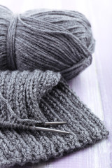 Fototapeta na wymiar Knitting with spokes on wooden background