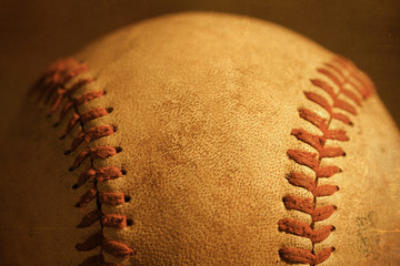 Baseball closeup showing stitches and seams with dirt