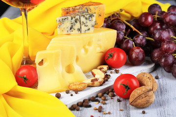 Different kinds of cheese with wine on table close-up