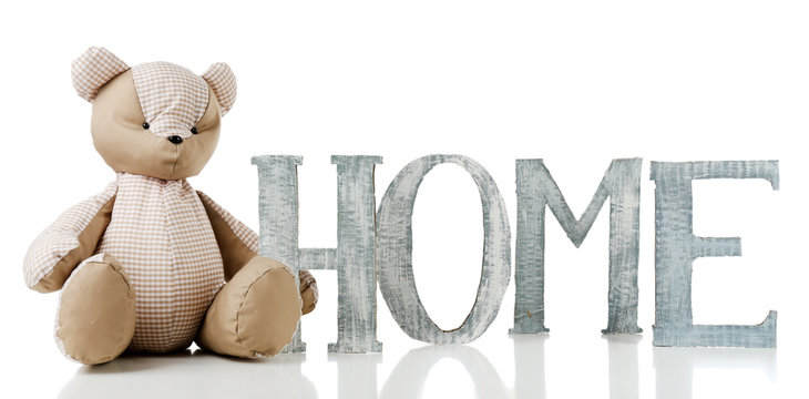 Decorative letters forming word HOME with teddy bear isolated