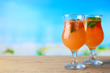 Grapefruit cocktail with cocktail straw on bright background