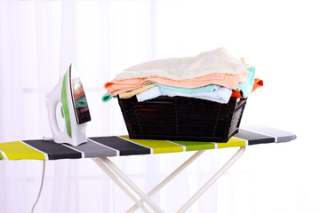 Basket with laundry and ironing board