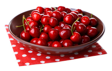 Sweet cherry on color plate isolated on white