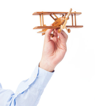 business man holding wooden airoplane on white background