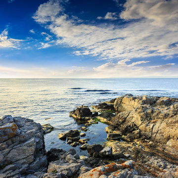 calm sea with boulders on coast