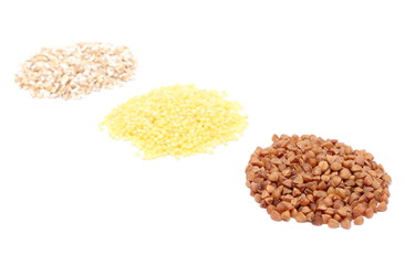Heap of buckwheat, millet and barley groats. White background
