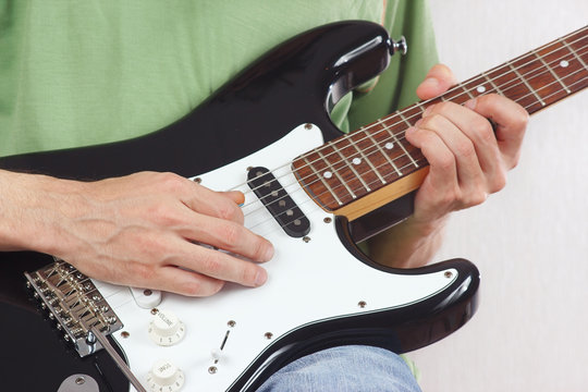Posing hands of the rock musician playing the electric guitar