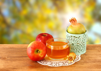 rosh hashanah concept - apple honey and pomegranate over wooden 