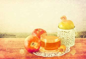 rosh hashanah concept - apple honey and pomegranate over wooden 