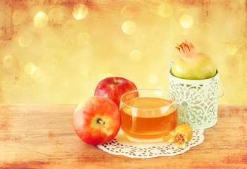 rosh hashanah concept - apple honey and pomegranate over wooden 