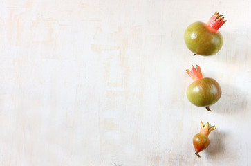 pomegranate symbols of rosh hashanah holiday over wooden backgro