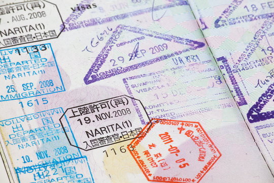 Close - up many international passport stamps