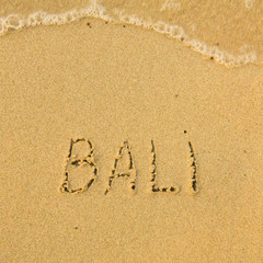 Bali - written in sand on beach texture.