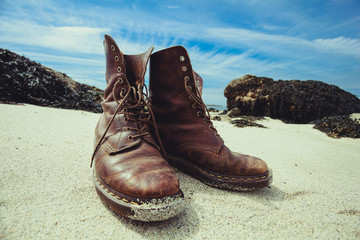 Pair of boots on the beach