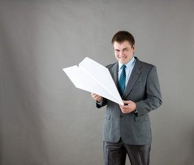 Businessman with paper plane in studio