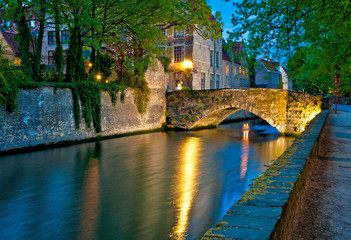 Fototapeta na wymiar Historic medieval buildings along a canal in Bruges, Belgium