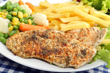 Chicken grilled fillet in herbs with fresh vegetable and fries