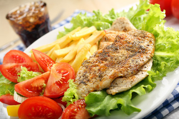 Chicken grilled fillet in herbs with fresh vegetable salad and f