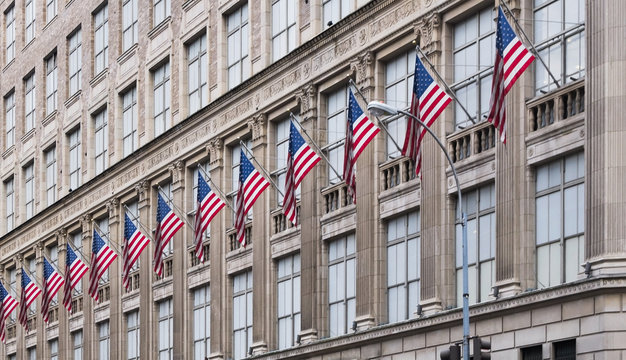 many american flags on old office building in New York
