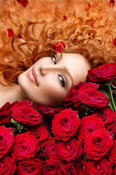 Woman with permed red hair and beautiful red roses