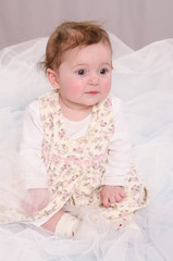 Six-month girl sitting in tulle