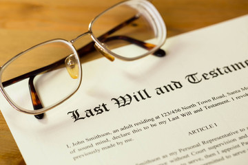 Last will and testament on cream color paper with glasses