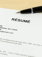 Resume with pen on table closeup