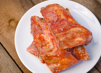 Spareribs on grill with hot marinade
