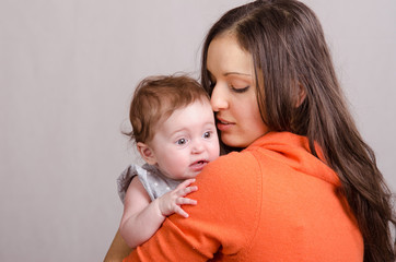 Six-month baby girl on mother's hands