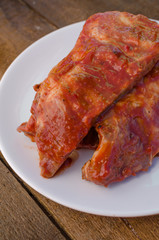 Spareribs on grill with hot marinade