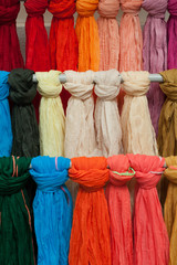 Colorful shawls or scarfes in a market stall