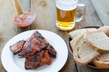 Spareribs on grill with hot marinade, czech beer
