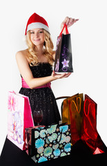 Blond woman in santa hat with shopping bags