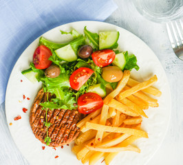 Steak with french fries and salad