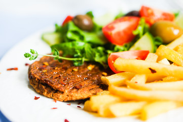 Steak with french fries and salad