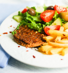 Steak with french fries and salad