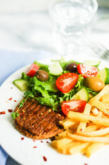 Steak with french fries and salad