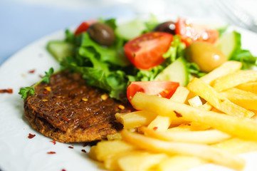 Steak with french fries and salad