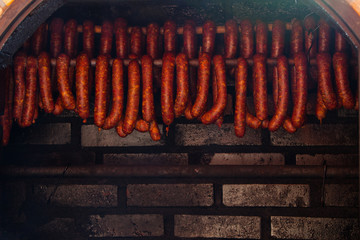 Traditional food. Smoked sausuages in smokehouse.
