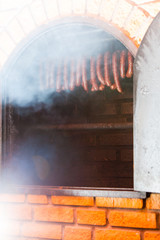 Traditional food. Smoked sausuages in smokehouse.