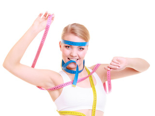Obsessed fitness woman with a lot of colorful measure tapes