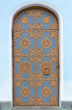 Vintage door with wrought ornament.