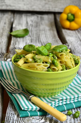Penne with pesto and green peas.