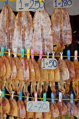 Row of Appetizing Dry Squids for Sale on Street,Thailand