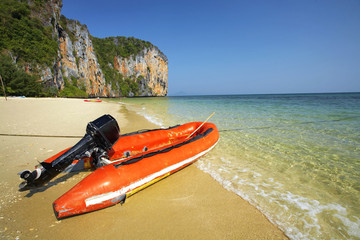 red rubber boat on beach