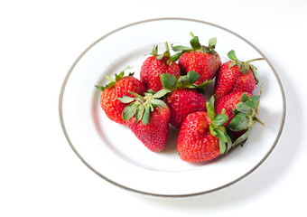 Ripe strawberries in a porcelain plate