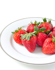Ripe strawberries in a porcelain plate