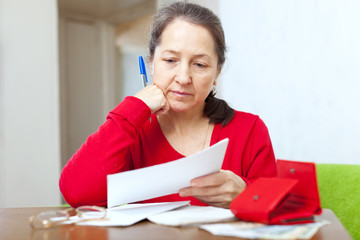 mature woman reads bills