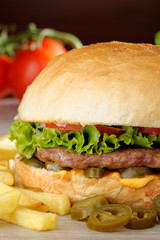 Big juicy Mexican burger with spicy jalapenos, nacho cheese