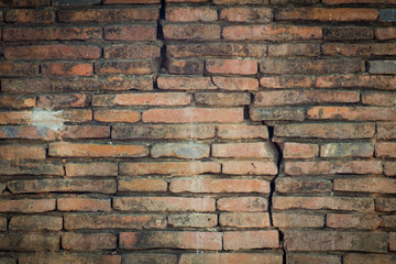 Weathered stained old brick wall background, with crack